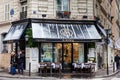 Tourists with luggage next to an Italian restaurant at a beautiful corner of Paris in winter Royalty Free Stock Photo