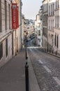 Paris, France, March 26, 2017: View on narrow cobbled street among traditional parisian buildings in Paris, France.