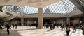 Paris, France - March 31, 2019: Visitors walking in the hall of Louvre Pyramid. Royalty Free Stock Photo