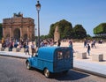 Ancient blue van - iconic Citroen 2CV Fourgonnette, back view. Arc de Triomphe du Carrousel at the background