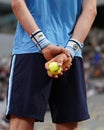 Ball boy holds Wilson Roland Garros tennis ball at Le Stade Roland Garros in Paris, France.