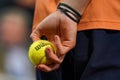 Ball boy holds Wilson Roland Garros tennis ball at Le Stade Roland Garros in Paris, France