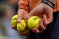 Ball boy holds Wilson Roland Garros tennis ball at Le Stade Roland Garros in Paris, France