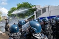 French police water cannon hosing down demonstrators at the end of a protest in Paris, France