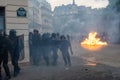 French riot police (CRS) momentarily retreating in front of many rioters in Paris, France Royalty Free Stock Photo