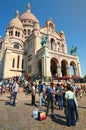 Illegal trade in Paris. A man illegally sells cold mineral water to tourists near famous Sacre Coeur Basilica at sunny spring day.