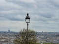 Paris, France - May 8th 2023: Historic lantern in front of an amazing view over the city from Sacre-Coeur