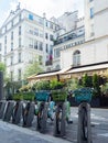 Paris, France - May 9th 2023: A velib bicycle renting station in front of historic buildings