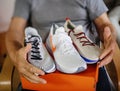 Tilt-shift photo of happy senior man unboxing Nike shoes