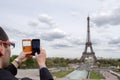 PARIS, FRANCE - MAY 2, 2016: Tourist taking pictures at Tour Eiffel town symbol Royalty Free Stock Photo