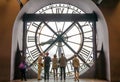 Paris, France - May 14, 2015: Tourists looking through the clock in the museum D'Orsay.