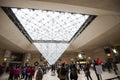 Visitors watching the Inverted Pyramid in Paris, France. The Inverted Pyramid is a skylight