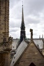 Notre Dame Spire, La Fleche, and roofs before the fire. View of the Apostles, angel statue, chimeras and gargoyles. Paris, France.