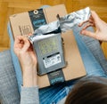 Woman unpacking unboxing Amazon Prime cardboard box HDD