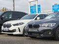 ront view of new luxury BMW cars parked outside dealership