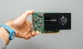 Man hand holding against gray background powerful NVIDIA GPU video card Royalty Free Stock Photo