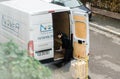 Man unloading goods from white delivery van