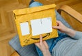 Woman unpacking unboxing Amazon Prime cardboard box