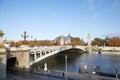 Alexander III bridge in Paris, people running and cycling in a sunny autumn morning