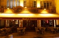Bistro called Vivienne in the heart of Paris. Traditional decor, terrace with green roof, tables and chairs. Historical