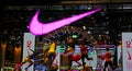 Closeup of display window of Nike store at night with neon light logo