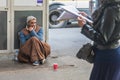 Homeless man sitting on the street Royalty Free Stock Photo
