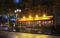 Typical Parisian cafe Marguerite at rainy night located next town hall of Paris .