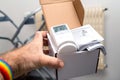 Male hand showing unboxed package of Vaillant Ambisense VR50 thermostatic valve