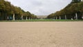 Scenic view of tourists travelling in Gardens of Versailles in Paris, France under a cloudy sky