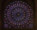 Closeup of stained glass of the oldest rose window installed in 1225 in the Notre Dame de Paris Cathedral in Paris France