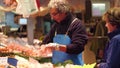 PARIS, FRANCE - OCTOBER 7, 2017. Vendor packing shrimps at fish and seafood stall at the local food market Royalty Free Stock Photo