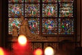 Paris, France - October 28, 2018: Interior of Notre Dame de Paris cathedral. Small altar with ancient statue and stained glass Royalty Free Stock Photo