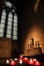 Paris, France - October 28, 2018: Interior of Notre Dame de Paris cathedral. Small altar with ancient statue and stained glass Royalty Free Stock Photo