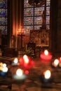 Paris, France - October 28, 2018: Interior of Notre Dame de Paris cathedral. Small altar with blurred offering candles on Royalty Free Stock Photo