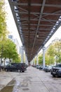 Modern street in Paris, France. Car parking under the railway bridge