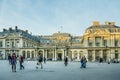 People are walking by the Conseil DÃ¢â¬â¢Etat in Paris, France