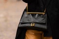 Paris, France - October, 1, 2022: woman wearing large crinkled leather crush chain shoulder bag from Balenciaga, street