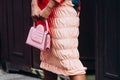 Paris, France - October, 3, 2021: woman wears clutch pink bag