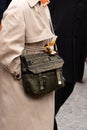 Paris, France - October, 3, 2022: woman wears green camouflage canvas diorcamp messenger bag with silver hardware from