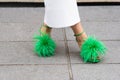 Paris, France - October, 3, 2022: woman wears green leather ostrich feather dot feather detailed sandals from Bottega