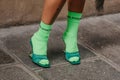 Paris, France - October, 3, 2021: woman wears green sandals with neon socks