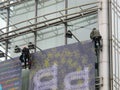 PARIS, FRANCE - OCTOBER 2012: Workmen setting up a huge billboard in Paris