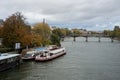 the touristics boats on the Seine river on the famous bridge of arts on background Royalty Free Stock Photo