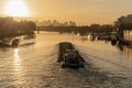 Paris, France - 01 30 2022: Quays of the Seine. View of the freight of a barge sailing along the Seine and The Defense district at