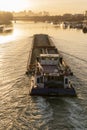 Paris, France - 01 30 2022: Quays of the Seine. View of the freight of a barge sailing along the Seine and The Defense district at