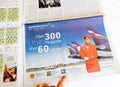 Man reading newspaper looking at Aeroflot Advertising