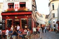 PARIS, FRANCE - 09 SEPTEMBER 2015: Cozy cafes and tourists on the street on Montmartre. Paris, France Royalty Free Stock Photo