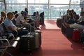 Passengers with suitcases are waiting for their flight in Terminal F at Charles de Gaulle Airport Royalty Free Stock Photo