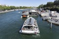 PARIS, FRANCE - SEPTEMBER 15, 2019: Pleasure boats at the quay of Seine river full of tourists. Some cruise ships unmoor the