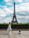 Asian bride waiting to be photographed for her trash the dress session with the Eiffel Tour